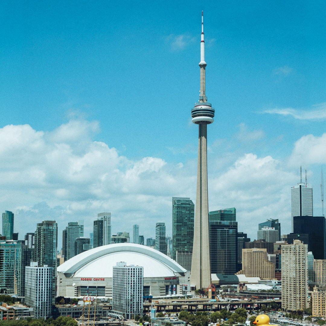 Toronto skyline with CN Tower and Rogers Centre under a blue sky